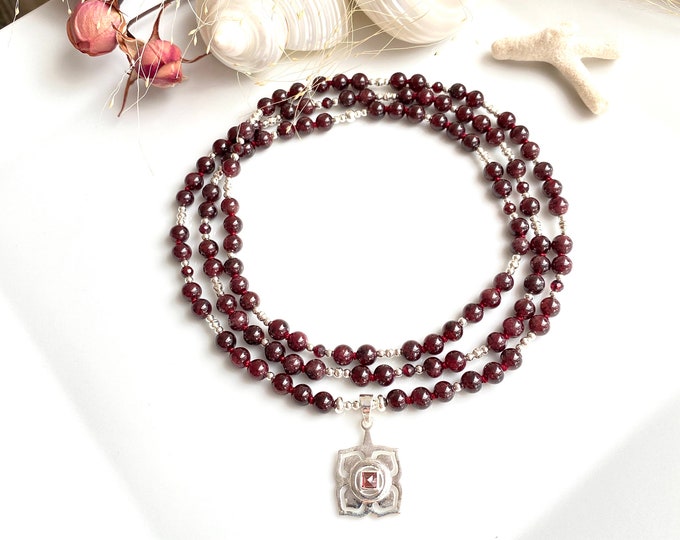 Mala made of red garnet (almandine) with a silver pendant with the root chakra symbol - Muladhara - chakra, prayer beads