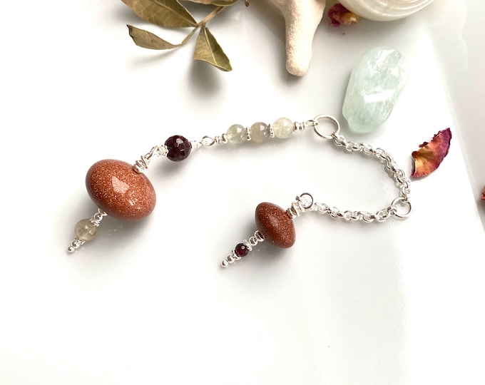 Pendulum made of gold flow, garnet, moonstone and silver, radiesthesia