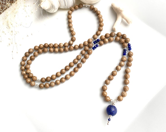 Aragonite mala decorated with lapis lazuli and silver sterling, lapis lazuli closing bead, "relief and growth"