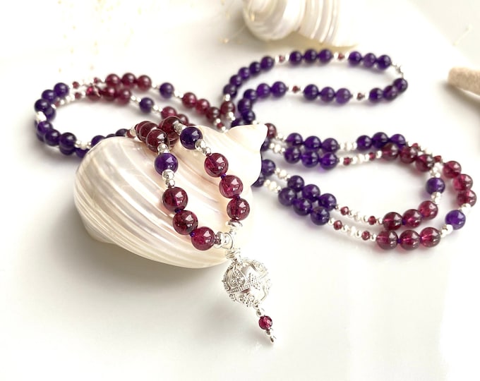 Extraordinary mala made of light amethyst and garnet, decorated with silver and purple garnet, final element silver ornamental bead