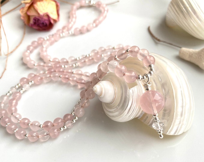 Long mala made of rose quartz (A, semi-transparent), decorated with silver, final bead made of rose quartz (A)