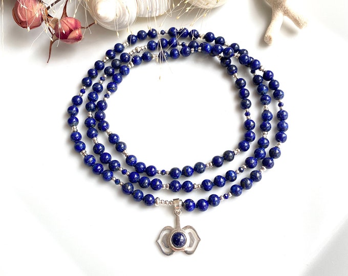 Mala made of lapis lazuli (A) with a silver pendant with the symbol for the 3rd eye - Ajna - Chakra, prayer beads