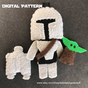 May include: A felt pattern for a Mandalorian and Grogu plush toy. The pattern includes a grey Mandalorian with a brown belt and a green Grogu with brown ears.