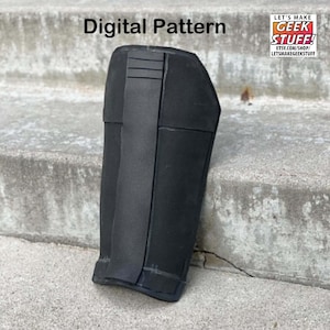 May include: A black forearm guard featuring a smooth matte finish with a vertical central panel and four horizontal ridges at the top. The text Digital Pattern is visible above the object, and a logo reads LET'S MAKE GEEK STUFF! ETSY.COM/SHOP/LETSMAKEGEEKSTUFF.