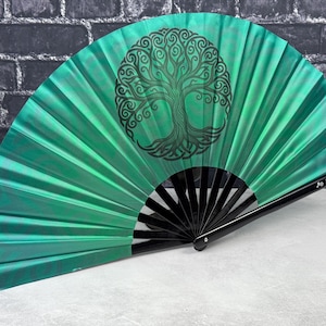 May include: A handheld folding fan with a vibrant emerald green fabric canopy featuring a black circular tree of life graphic. The fan has black plastic ribs and a handle with the text Jinger-Print.com printed in white on the side.