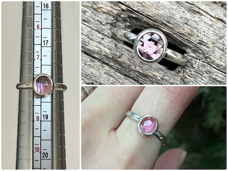 May include: A silver ring with a pink gemstone. The ring is shown on a ring sizer and on a finger.