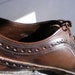 May include: Close-up of the inside of a brown leather shoe with a lace-up closure. The shoe has a brogue design with decorative perforations. The inside of the shoe shows the size 11 1/2 and the number 3723.