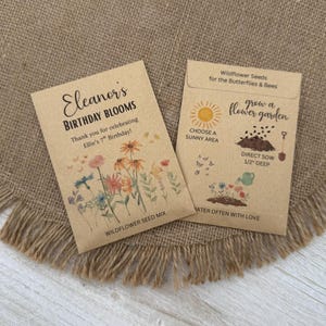 May include: Two brown seed packets with floral illustrations and text. One reads "Eleanor's Birthday Blooms" and thanks the recipient for celebrating Ellie's 7th birthday. The other packet says "Wildflower Seeds for the Butterflies & Bees."