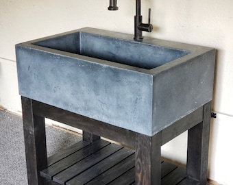 Light Blue Concrete Farmhouse Sink With Black Stained Base.