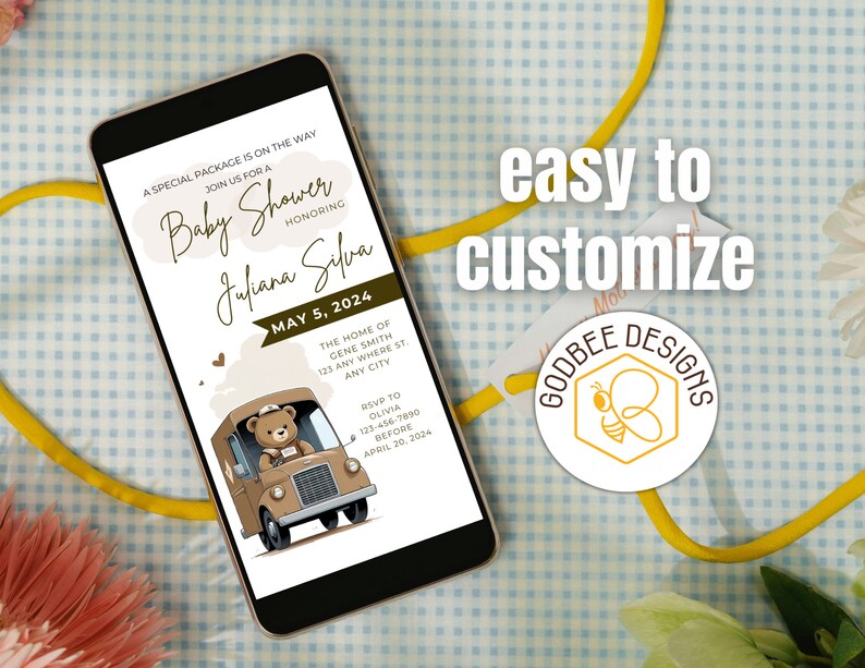 May include: A smartphone displays a baby shower invitation. The invitation features text, including the date, honoree's name, and RSVP information. A cartoon teddy bear drives a brown truck. The words "easy to customize" are also visible.