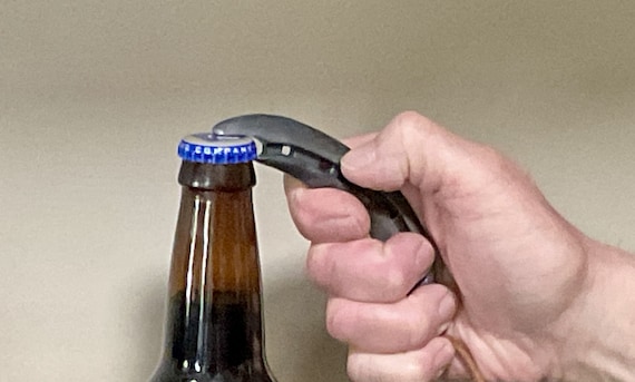 A real horseshoe hammered into a bottle opener — cowboy-core functionality with genuine blacksmith provenance.