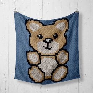 May include: A blue crocheted blanket with a brown teddy bear design. The bear is sitting with its arms outstretched and has a white belly.