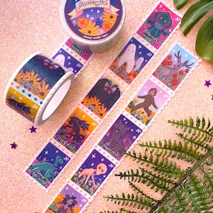 May include: A roll of floral cryptid themed washi tape with a purple, blue, and white background. The tape features illustrations of various cryptids, including the Mothman, Jersey Devil, Jackalope, and Flatwoods Monster. The tape is 25mm wide and 5m long.