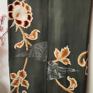 May include: A dark green kimono with a floral pattern in shades of brown and cream. The kimono has a traditional Japanese design with intricate details.