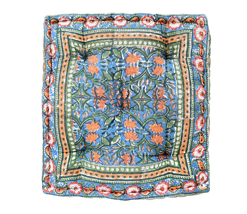May include: A blue and orange floral patterned cushion with a quilted design and a decorative border.