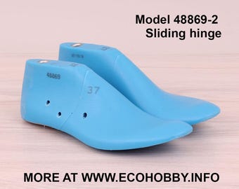 May include: Two light blue shoe lasts, with the text "Model 48869-2 Sliding hinge" and the number "37" visible. The lasts are made of a smooth material and are designed to shape shoes. The website address "MORE AT WWW.ECOHOBBY.INFO" is also visible.