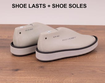 May include: Two beige shoe lasts with black soles and trim are displayed on a wooden surface. The text "SHOE LASTS + SHOE SOLES" is at the top of the image. One last has the text "ECO HOBBY" on the side.