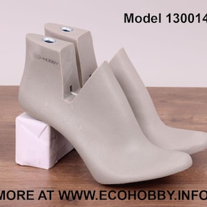 May include: A pair of gray shoe forms, one on top of the other, with the text "ECO-HOBBY" printed on the side. The shoe forms are labeled "Model 130014".