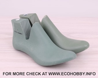 May include: A pair of green shoe lasts with the text "ECO-HOBBY" printed on one of the lasts.