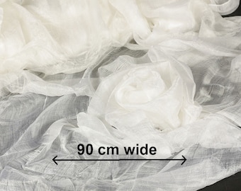 May include: White sheer fabric with a soft, delicate texture. The fabric is 90 inches wide.