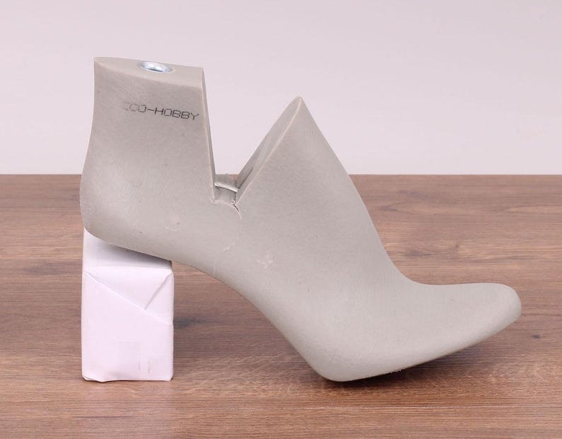 May include: A gray shoe form with a high heel and a cutout on the side. The form is labeled "300-HOBBY".