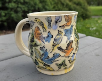 Functional handmade ceramic coffee mug with bird and flower print