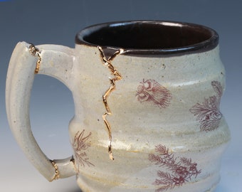 Kintsugi inspired wabi sabi functional handmade ceramic coffee or tea mug with images of conifer foliage and real gold luster