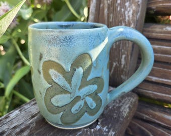Functional handmade ceramic coffee mug with layered green glaze
