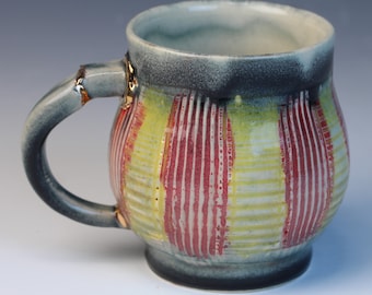 Kintsugi, Wabi Sabi inspired functional handmade black and red ceramic coffee or tea mug with texture and decorative real 22k gold repair