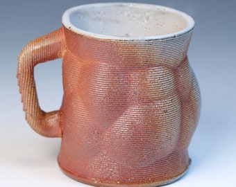 3D printed fully functional ceramic coffee or tea mug high fired reduction stoneware with a soda glaze. Has a white shino liner glaze inside