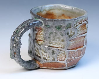 kurinuki coffee or tea mug with a 3D printed handle. Fully functional high fired and soda glazed stoneware with a white shino liner glaze.