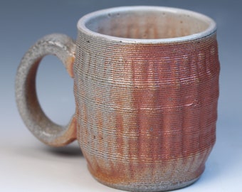 3D printed fully functional ceramic coffee or tea mug high fired reduction stoneware with a soda glaze. Has a white shino liner glaze inside