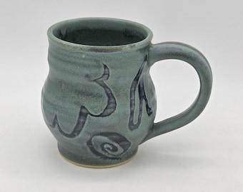 Functional handmade ceramic coffee mug with layered green glaze