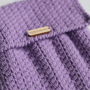 May include: A purple knitted pouch with a wooden tag that says "rich textures".