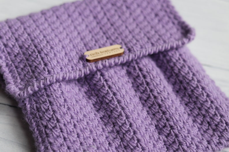 May include: A purple knitted pouch with a wooden tag that says "rich textures".