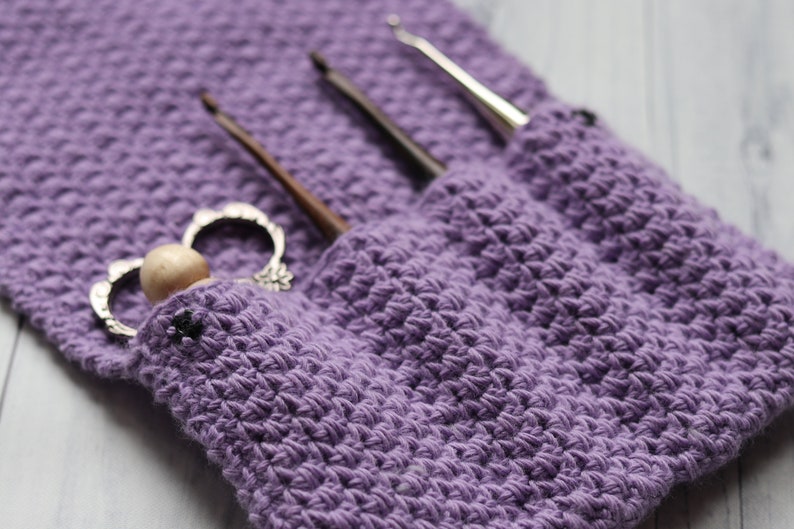 May include: Purple crocheted pouch with three crochet hooks and a vintage-style crochet hook holder.