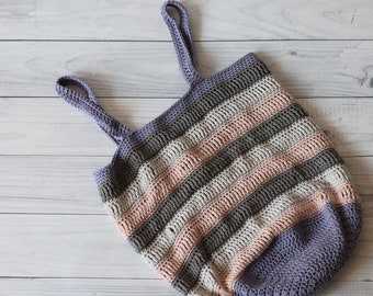 May include: A striped crocheted tote bag with purple, pink, beige, and gray stripes. The bag has two long straps.