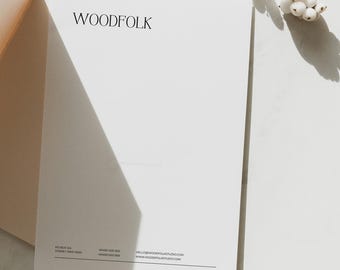 May include: A white letterhead with the word "WOODFOLK" printed in black at the top. The company's contact information is printed at the bottom of the page, including the address, phone number, and email address.