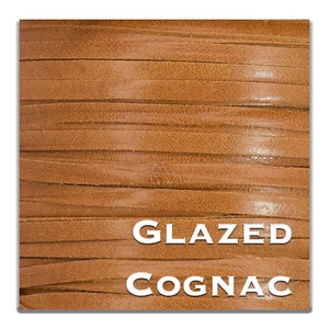 May include: Close-up of a stack of brown leather strips with a glossy finish. The text "GLAZED COGNAC" is printed in white on the leather.