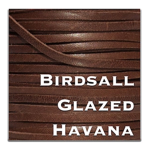 May include: Close-up of a spool of brown leather cord labeled "Birdsall Glazed Havana".