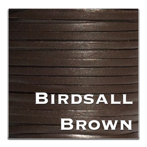 May include: Close-up of a spool of dark brown leather cord. The cord is flat and rectangular, tightly wound, and has a textured surface. The text "BIRDSALL BROWN" is displayed in white.