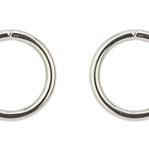 May include: Two silver metal rings, each with a diameter of approximately 1 inch.
