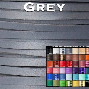 May include: Close-up of a gray leather cord, showing the texture of the material. A color chart of various leather colors is visible in the bottom right corner, with the text "DANECRAFT DESIGNS PACKER LEATHER" above it. The chart includes colors like black, white, saddle tan, chocolate, dark brown, bronze, red, orange, purple, blue, green, yellow, and more. The chart also includes the text "LACING WIDTHS" with measurements in inches.