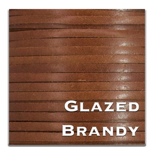 May include: Close-up of glazed brandy leather strips. The strips are a rich brown color with a glossy finish. The words "GLAZED" and "BRANDY" are displayed in white text.