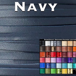 May include: A close-up of a navy blue leather strip. The strip is textured and has a slight sheen. The image also shows a color chart of different leather colors, including black, white, gray, brown, red, orange, yellow, green, blue, purple, and pink. The chart also includes the text "DANECRAFT DESIGNS PACKER LEATHER" and "LACING WIDTHS".