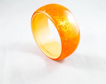 Stunning Acrylic Bangle in Orange with Cream Interior and encased red sparkle