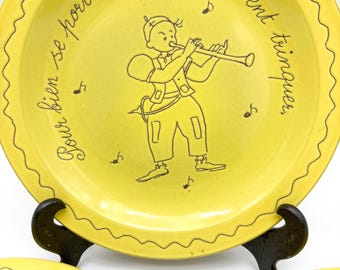 3 Piece French Collectors Plates Featuring raised illustrations of children playing instruments and French cursive text.