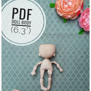 May include: A PDF pattern for a 6.3 inch doll body. The pattern is printed on white paper and is surrounded by pink flowers on a teal background.