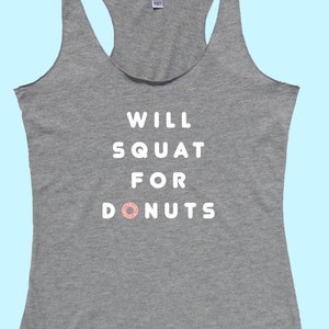 May include: Gray tank top with the text "WILL SQUAT FOR DONUTS" in white with a pink and white donut graphic.