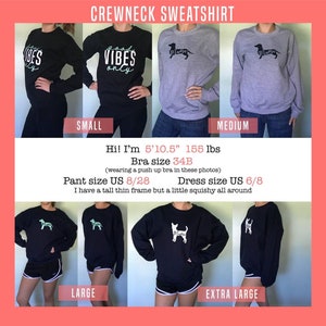 May include: A model is wearing a black crewneck sweatshirt with the text "good vibes only" in white. The sweatshirt is available in sizes small, medium, large, and extra large.